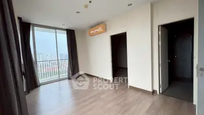 Spacious apartment with balcony and city view, featuring modern flooring and air conditioning.