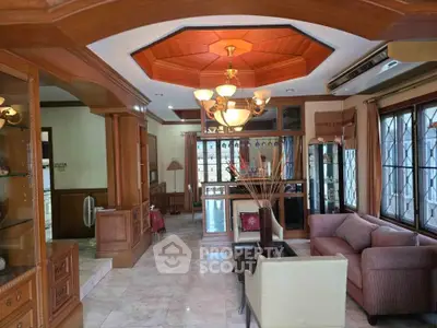 Spacious living room with elegant wooden ceiling and cozy seating area