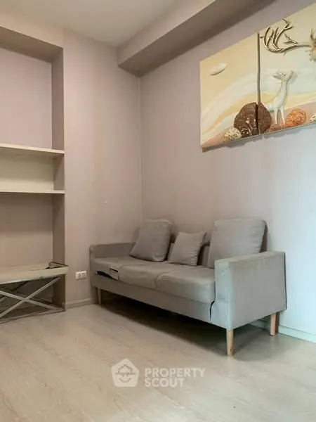 Cozy living room with modern sofa and stylish wall art, perfect for relaxation.
