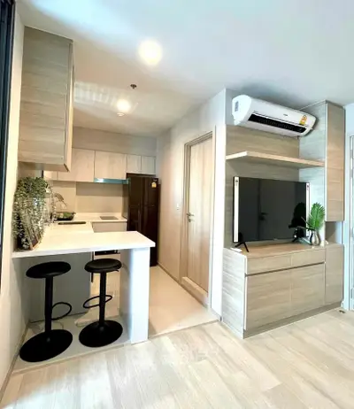 Modern open-plan living room with stylish kitchen and sleek appliances