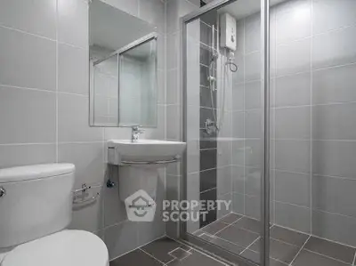 Modern bathroom with sleek shower and minimalist design.