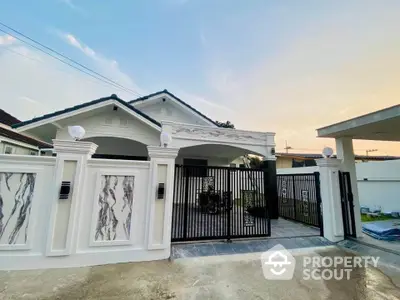 Charming single-story house with elegant gated entrance and modern design.