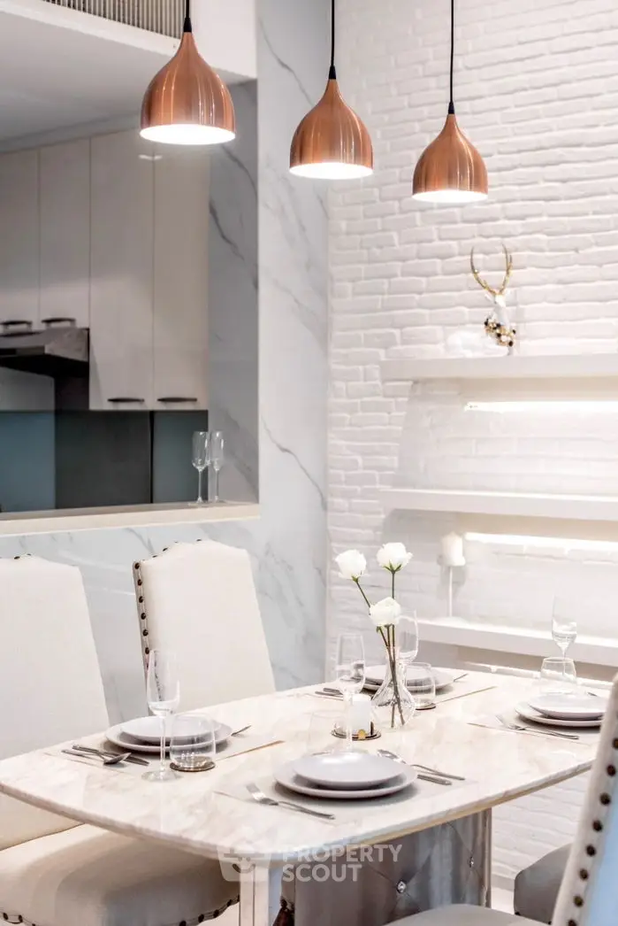 Elegant dining area with marble table and modern lighting in stylish apartment