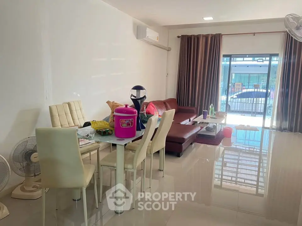 Spacious living room with modern furniture and large window offering natural light.