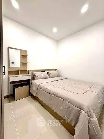 Cozy bedroom with modern furnishings and neutral tones, perfect for relaxation and comfort.