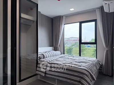 Modern bedroom with large window and stylish decor in urban apartment
