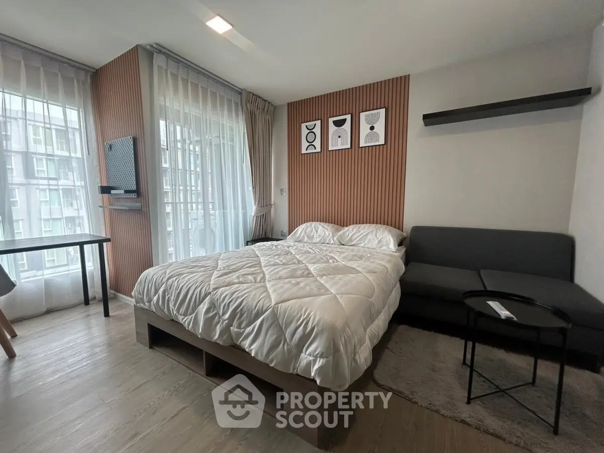 Modern bedroom with stylish decor and large windows in a contemporary apartment