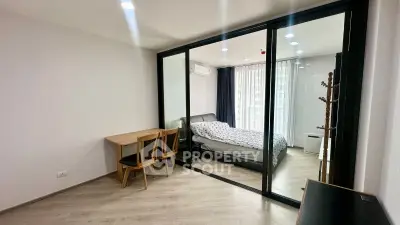 Modern bedroom with glass partition and cozy decor in a stylish apartment.