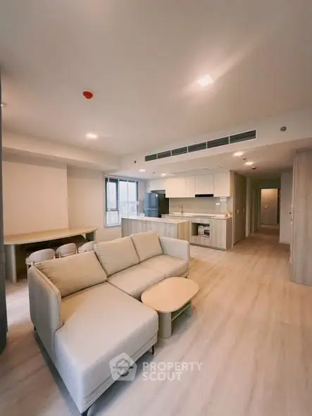Spacious modern living room with open kitchen layout and stylish furniture