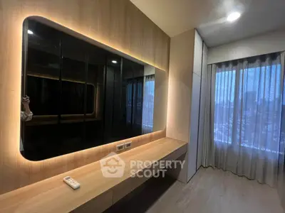 Modern bedroom with sleek built-in wardrobe and large window offering city views.