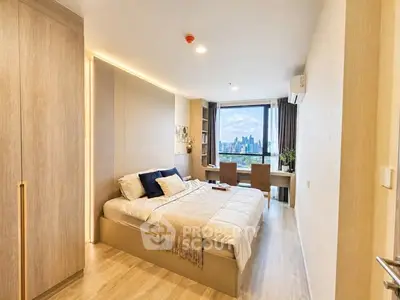Modern bedroom with city view, featuring stylish decor and ample natural light.