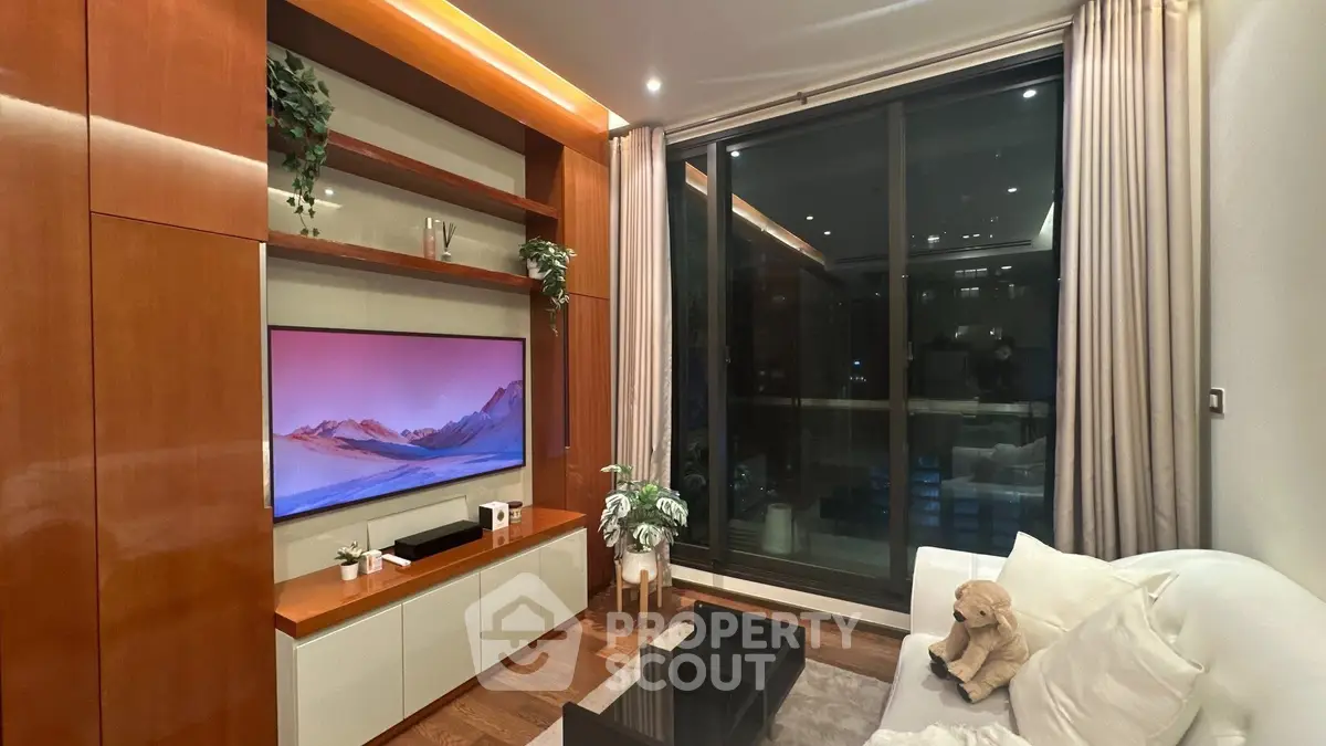 Luxurious living room with modern entertainment center and large window view.