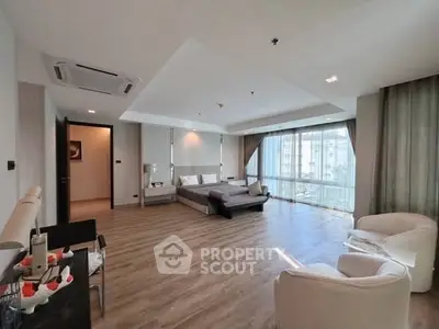 Spacious modern bedroom with large windows and elegant furnishings