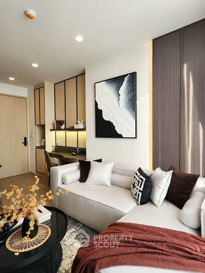 Modern living room with stylish decor, cozy sofa, and elegant wall art in a contemporary apartment.