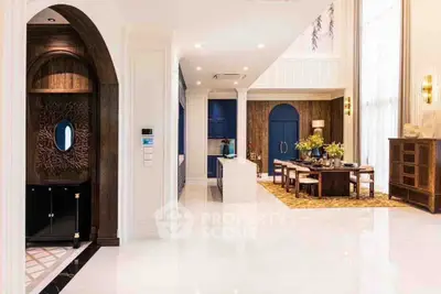 Luxurious open-plan living and dining area with elegant decor and high ceilings