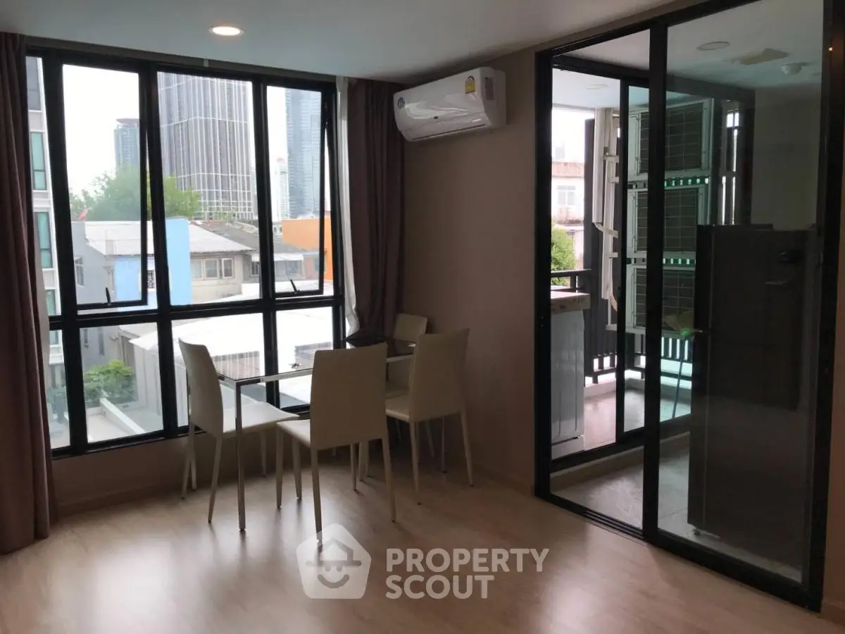 Modern apartment dining area with large windows and city view
