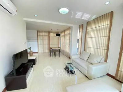 Spacious living room with modern decor and natural light in a stylish apartment.