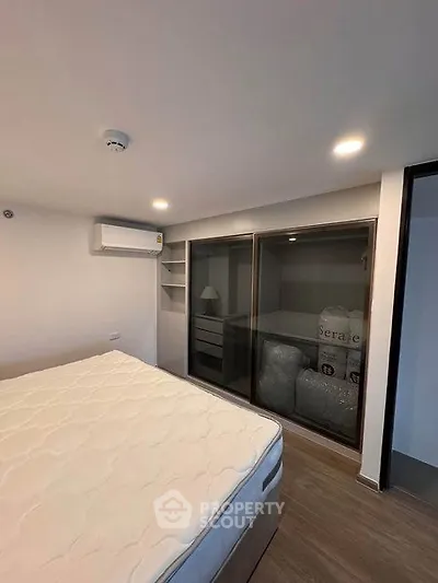 Modern bedroom with air conditioning and ample storage space