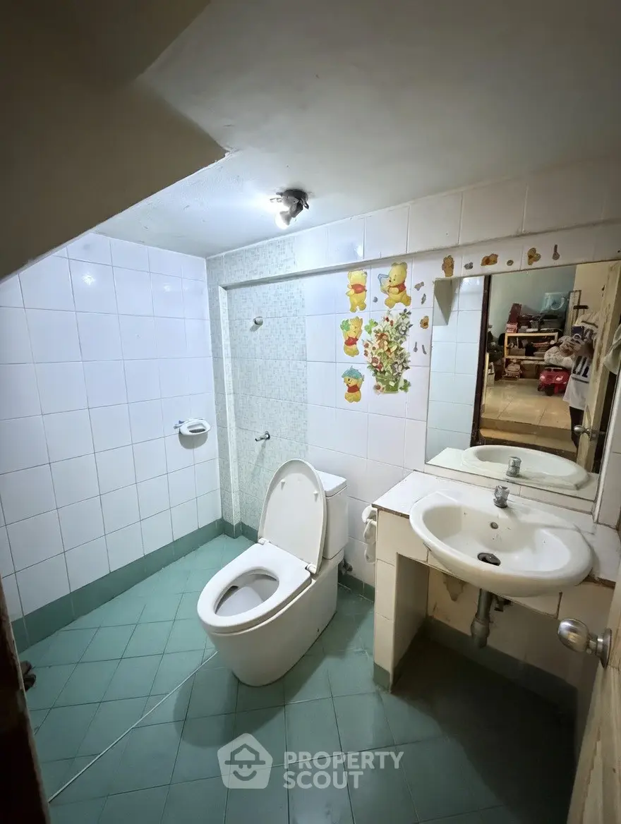 Cozy bathroom with modern fixtures and charming wall decor, perfect for a comfortable living space.