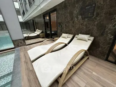 Luxurious indoor pool area with elegant lounge chairs and modern design