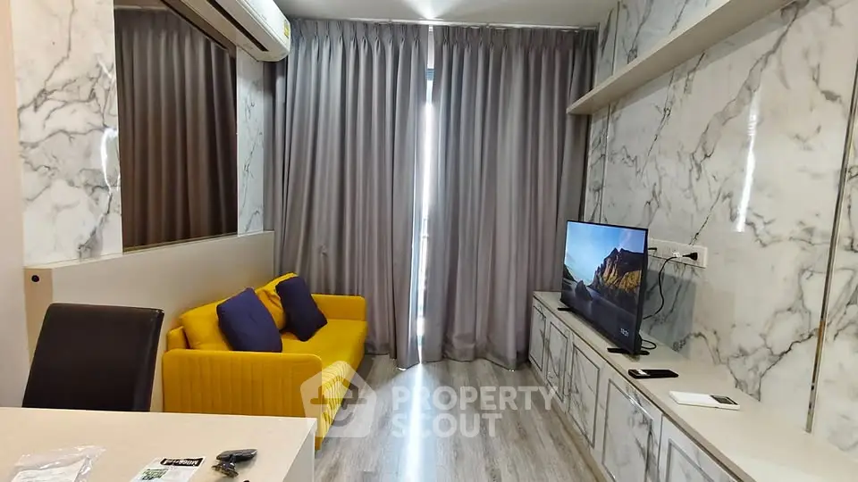 Modern living room with marble walls, yellow sofa, and flat-screen TV, perfect for stylish urban living.