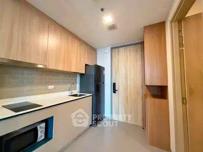 Modern kitchen with sleek cabinetry and built-in appliances in a stylish apartment.