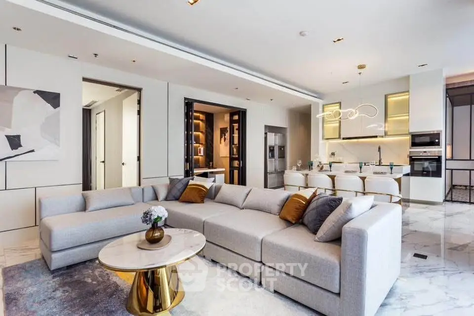 Luxurious modern living room with open kitchen, elegant decor, and stylish lighting in a high-end apartment.
