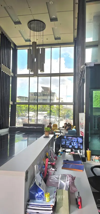 Modern building lobby with high ceilings and large windows offering natural light.