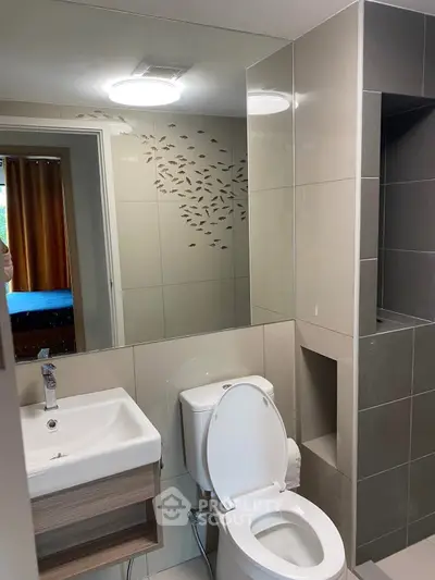 Modern bathroom with sleek fixtures and decorative wall design