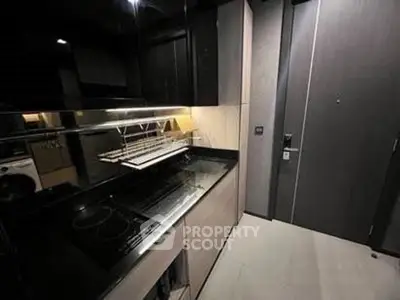 Modern kitchen with sleek black cabinetry and electric stove