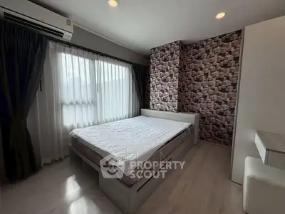 Modern bedroom with stylish wallpaper and ample natural light