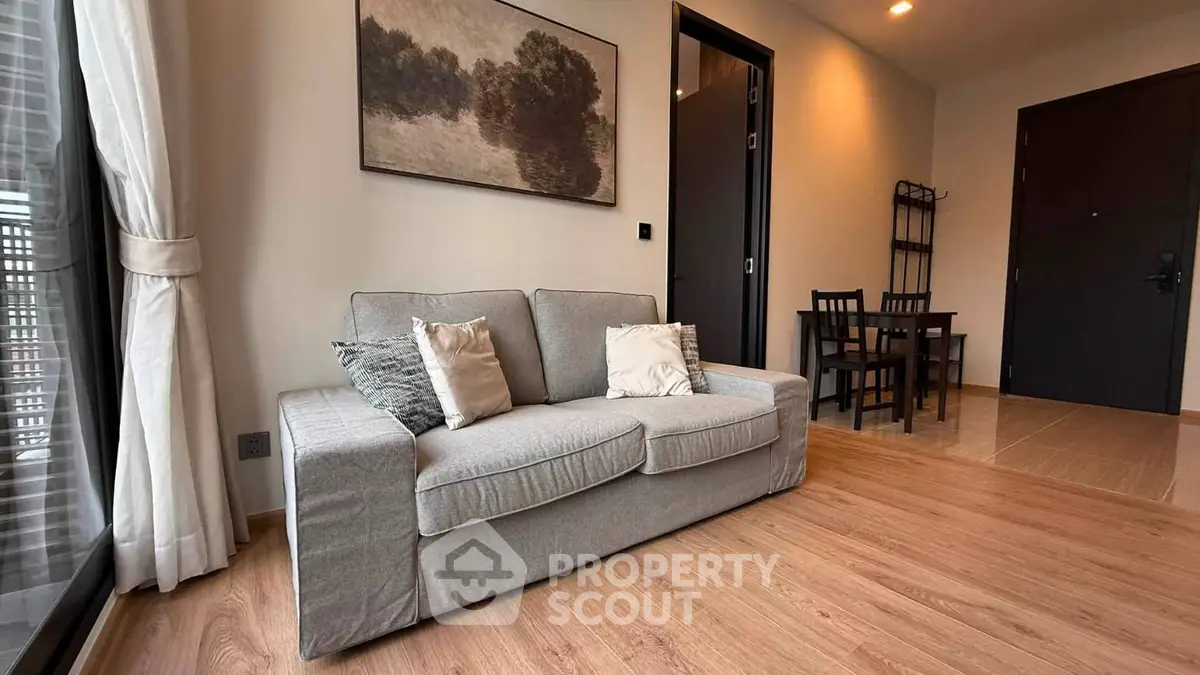 Modern living room with cozy gray sofa and elegant wooden flooring