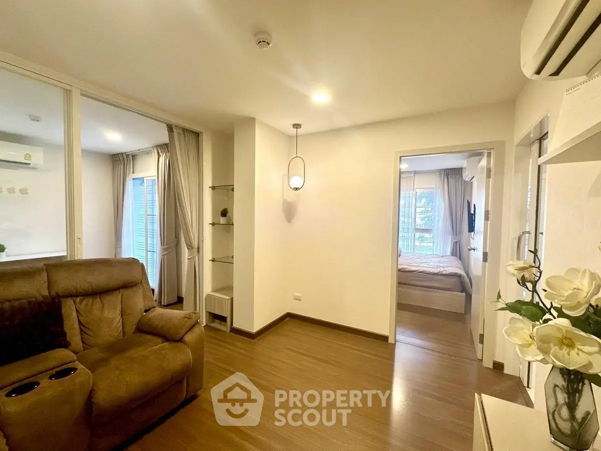 Modern apartment interior with cozy living room and bedroom, featuring elegant lighting and stylish decor.