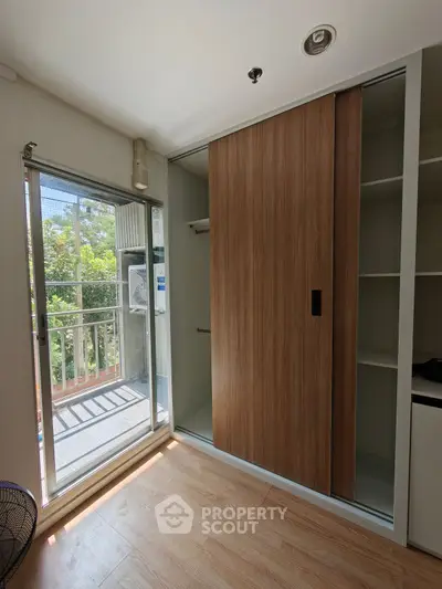 Modern bedroom with sliding wardrobe and balcony view