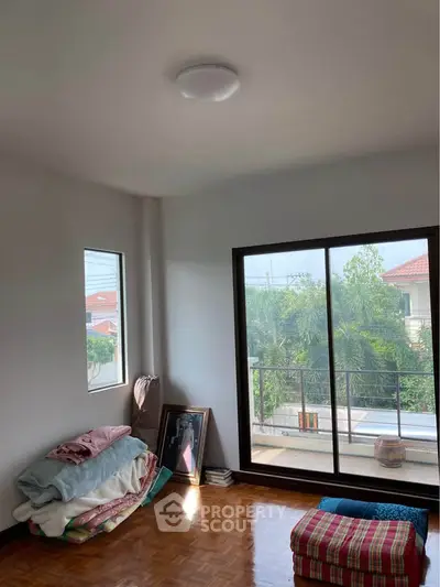 Bright room with large window and balcony access, showcasing potential for cozy living space.
