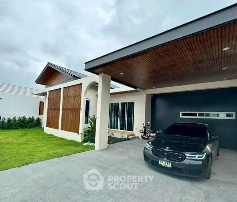 Modern single-story home with sleek carport and manicured lawn, showcasing contemporary architecture and design.