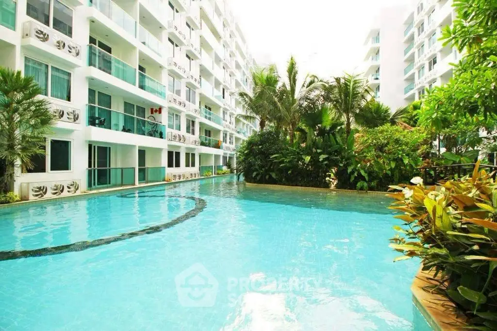 Luxurious apartment complex with stunning pool and lush greenery