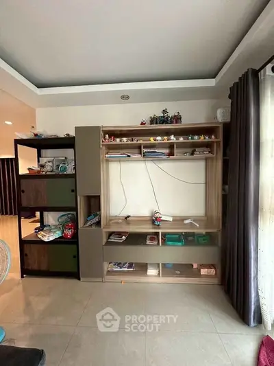 Spacious living room with modern shelving unit and natural light