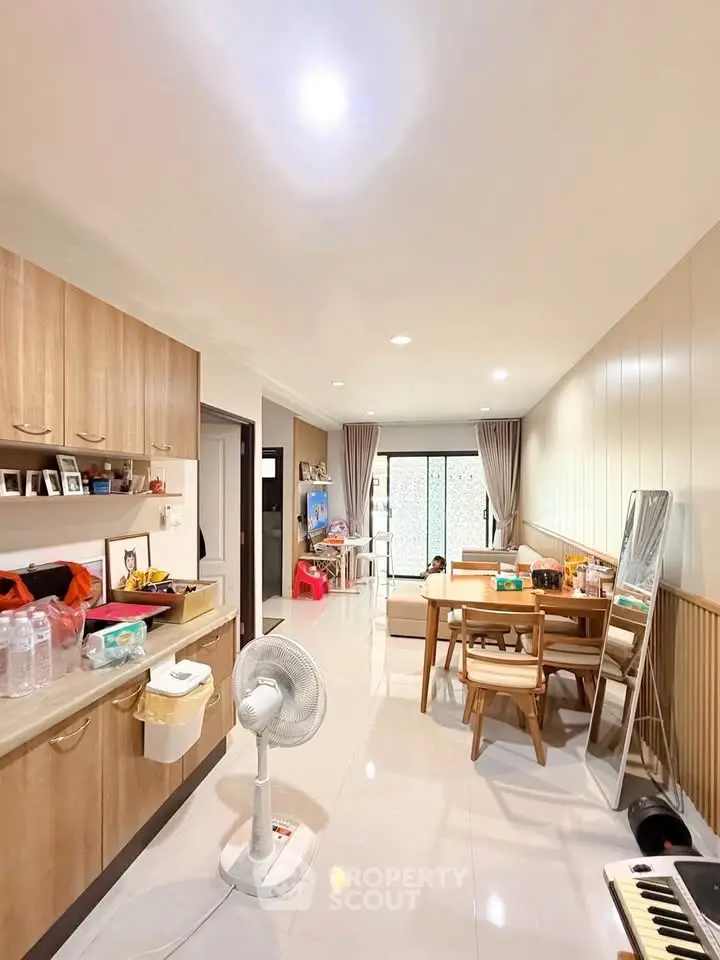 Spacious living room with modern decor and natural light, perfect for family gatherings.