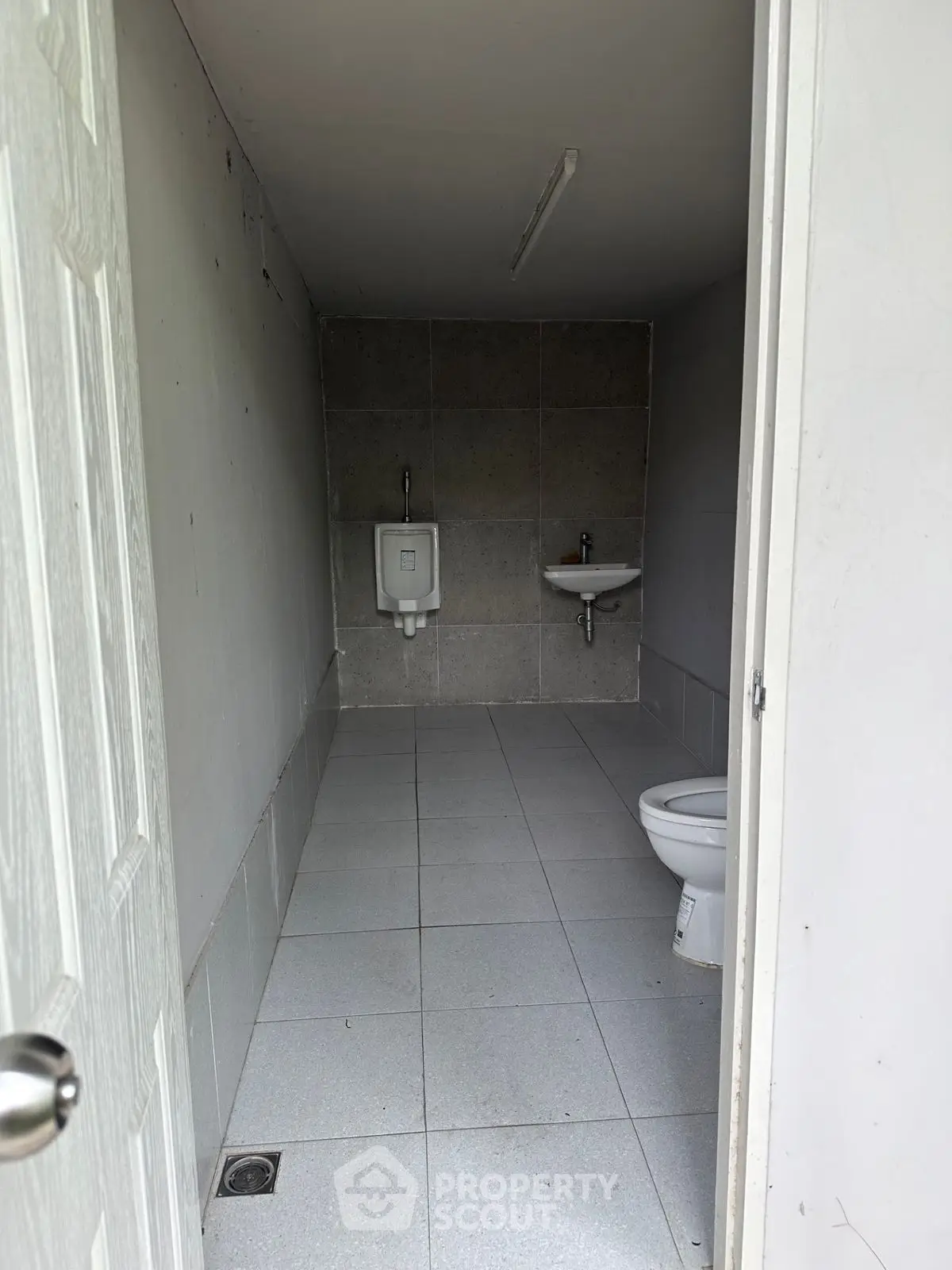 Compact and functional bathroom with essential fixtures in minimalist design.