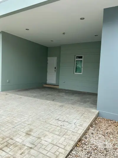 Modern house entrance with minimalist design and paved driveway