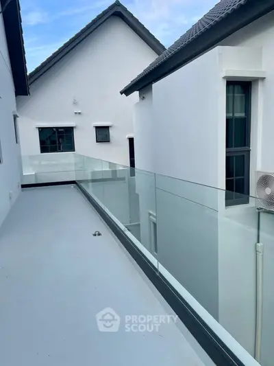 Modern balcony with glass railing in contemporary residential building