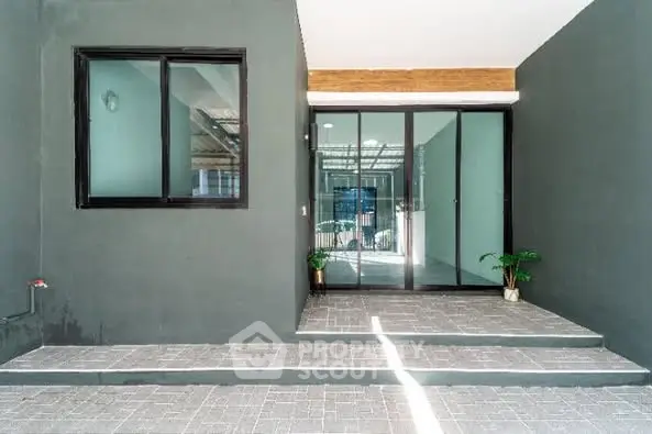 Modern entrance with sleek glass doors and minimalist design