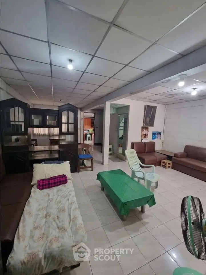 Spacious living room with cozy seating and ample natural light, perfect for family gatherings.