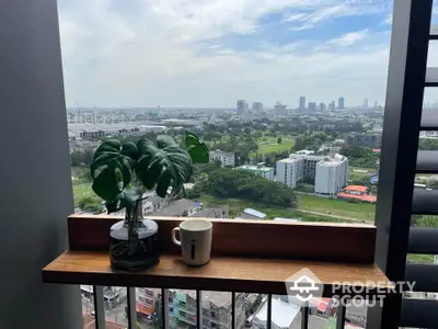 Stunning city view from a high-rise balcony with lush greenery and skyline.