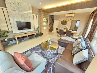 Luxurious living room with modern decor and open dining area, perfect for entertaining.