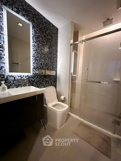 Modern bathroom with sleek design and glass shower enclosure