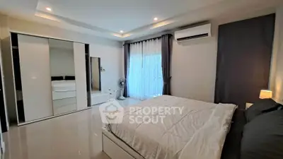 Spacious modern bedroom with sleek design and ample natural light