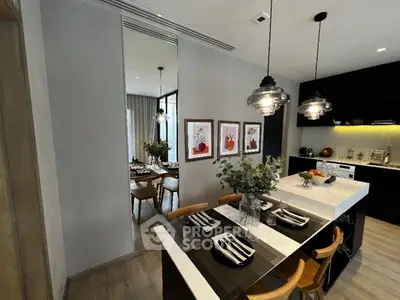 Modern kitchen with stylish island and dining area, featuring pendant lighting and contemporary decor.