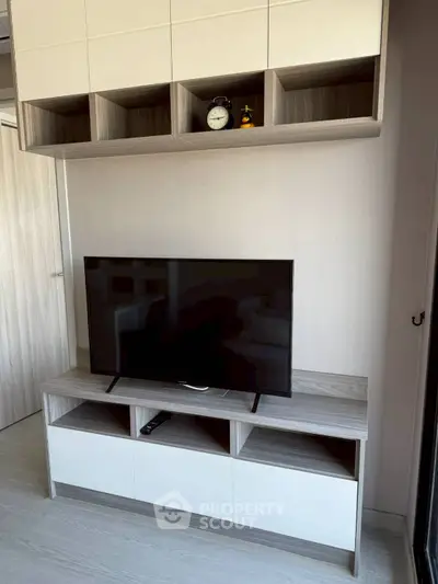 Modern living room with sleek TV stand and wall-mounted storage cabinets